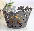 Detail of dark grey four-leaf clover laser-cut cupcake wrappers for wedding decor - Silver Charcoal