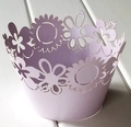 Close-up of laser-cut lavender cupcake wrappers with intricate floral daisy pattern - Light Purple