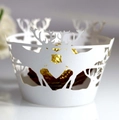 White laser-cut reindeer cupcake wrapper with a golden chocolate ball for Christmas decor - White