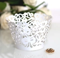 Laser-cut white cupcake wrappers with elegant floral lace patterns for wedding decor - White