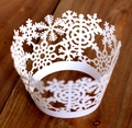 Detailed laser-cut white cupcake wrapper with snowflake patterns on wood background - Various Snowflake Textures (WB-250)