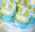 Detail of light blue laser-cut cupcake wrappers with intricate floral hollow design - Sky Blue