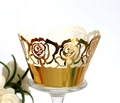 Macro view of gold laser-cut cupcake wrappers with intricate floral rose patterns - Reflective Gold