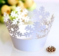 Macro shot of laser-cut white snowflake cupcake liners with elegant crown design - Snowflake Crown Style (WB-215)