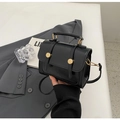 Detail of a vintage black glossy leather handbag with gold buckles and a shoulder strap d-ring - No Pendant / Black