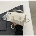 Detail of a beige mini faux leather handbag featuring a gold rotary clasp and top handle - No Pendant / Off White