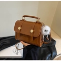 Retro caramel brown PU leather crossbody handbag with white plush monster charm - With Charm / Brown