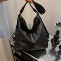 Large capacity black PU leather tote bag with wide strap in a minimalist hobo style - Black
