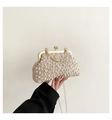 Detail of champagne pleated evening clutch featuring pearl embellishments and a gold chain - Khaki