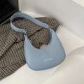 Minimalist light blue crescent hobo bag with white fashion lettering on stylish blazer - Blue