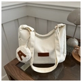 Detailed texture of off-white corduroy tote bag with fashion leather tag and small coin pouch - White