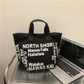 Black canvas tote bag with white street-style typographic print and top handles - Black