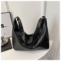 Close-up of a black leather tote bag with pleated crescent design and metallic zipper - Black Without Pendant