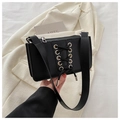 Detail of black patent leather shoulder bag featuring silver eyelets and cross-lace design - Black
