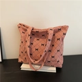Pink corduroy tote bag with black bow lattice pattern and spacious shoulder straps - Pink
