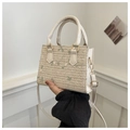 Mini cream woven straw crossbody bag featuring delicate green floral embroidery - White