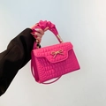 Rose red handbag with crocodile pattern, golden bow hardware and pleated handle detail - Pink