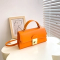 Chic vibrant orange leather handbag with gold metal lock and shoulder strap detail - Orange