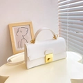 Elegant white crossbody box bag with gold twist lock and a smooth leather finish - White