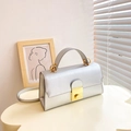 Silver structured crossbody bag with gold turn-lock and metallic finish for daily style - Silver