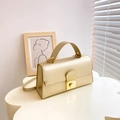 Elegant gold minimalist crossbody handbag with metallic lock and rounded top handle - Champagne