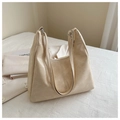 Detail of cream faux leather tote showing soft texture, silver buckle, and zipper closure - Khaki