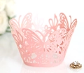 Macro view of laser-cut butterfly cupcake wrapper in soft pink paper for dessert decor - Pink