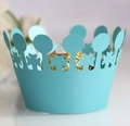 Macro view of laser-cut light blue pearl paper cupcake wrappers with crown edge - Turquoise Blue