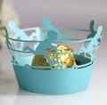 Detail of light blue laser cut cupcake wrapper with hollow boy silhouette and gold candy - Tiffany Blue