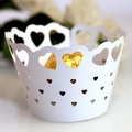Macro detail of laser-cut heart pattern cupcake wrapper with gold chocolate accent - White