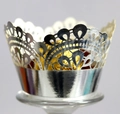 Macro shot of silver hollow lace cupcake wrapper with intricate laser-cut wave patterns - Reflective Silver