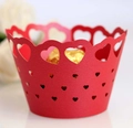 Macro detail of red paper cupcake wrapper with intricate laser-cut hollow heart pattern - Pearlescent Red