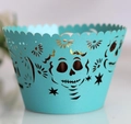 Intricate laser-cut skull and star patterns on a turquoise cupcake wrapper detail - Tiffany Blue