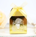 Close-up of laser-cut gold mirror wedding favor box with floral patterns and a silk ribbon - Reflective Gold