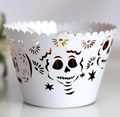 Detailed laser-cut white cupcake wrapper with intricate sugar skull and star patterns - White