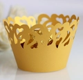 Macro shot of gold laser-cut cupcake wrappers with elegant hollow heart patterns - 5cm / Gold