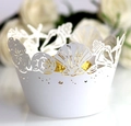Close-up of laser-cut ocean theme cupcake wrappers with white shell and starfish patterns - White / 5cm