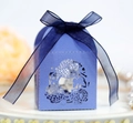 Macro detail of laser-cut hollow house-shaped wedding candy box with a blue ribbon bow - Sapphire Blue