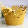 Macro shot of gold laser-cut pearl paper cupcake wrappers with seashell and starfish motifs - Gold / 5cm