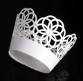 Macro view of laser-cut white pearlescent paper cupcake wrappers with crown flower patterns - 5cm / White
