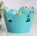 Detailed view of turquoise laser-cut heart pattern cupcake wrapper with gold chocolate - Turquoise Blue