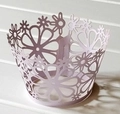 Detail view of lavender laser-cut floral paper cupcake wrappers for wedding decor - Light Purple