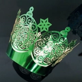 Macro detail of green laser-cut cupcake wrapper with intricate spiral patterns - Reflective Green