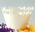Close-up of laser-cut white cupcake wrapper featuring intricate star and geometric patterns - Ivory