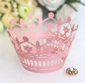 Detail of pink laser-cut crown cupcake wrapper featuring a gold rhinestone accent - Pink