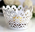 Macro shot of white laser-cut lace cupcake wrapper with decorative scroll patterns - 5cm / White