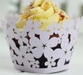 Close-up of white laser-cut floral cupcake wrappers with intricate hollow patterns - 5cm / Light Purple