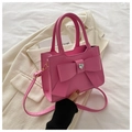 Hot pink crossbody bag with large bow and heart rhinestone on a clean background - Deep Pink