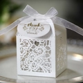 Detail of white lace laser-cut wedding favor box with ribbon and thank you tag - Ivory