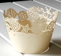 Macro detail of laser-cut cupcake wrappers featuring ocean seashell and starfish patterns - 5cm / Jewel Star Beige
